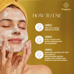 Woman with a yellow headband washing face with foaming cleanser, Trisatva skincare how to use steps